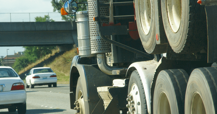 Semi truck on highway with passenger cars